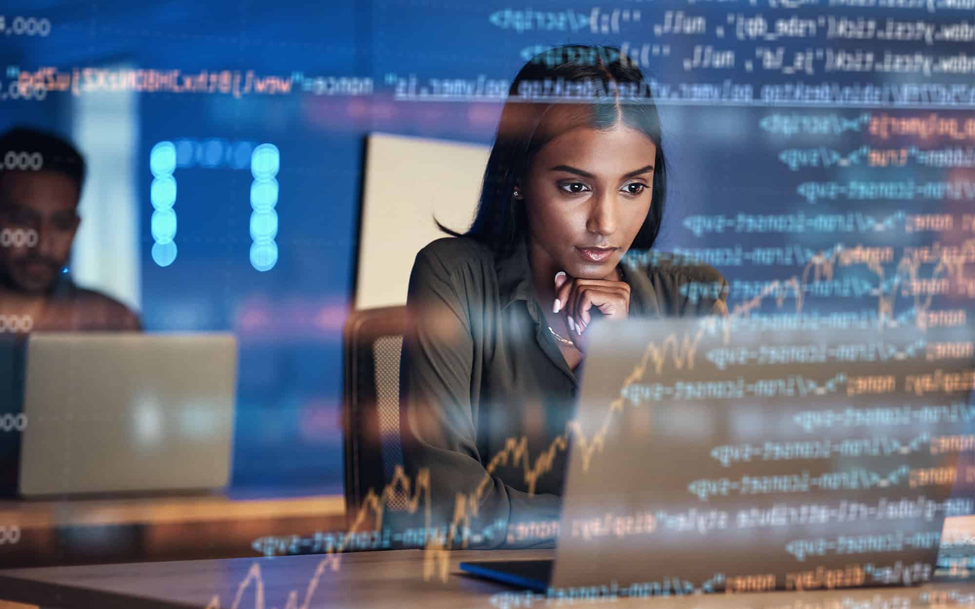 Woman at Desk Reading Code Augmented in Front of Her