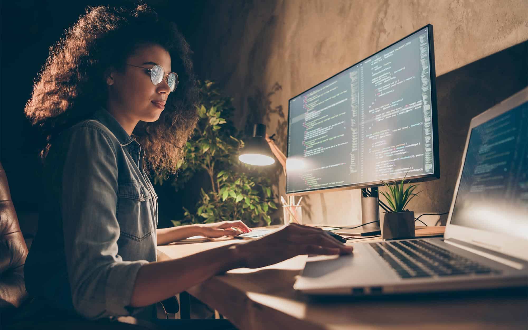 Professional looking at code on computer