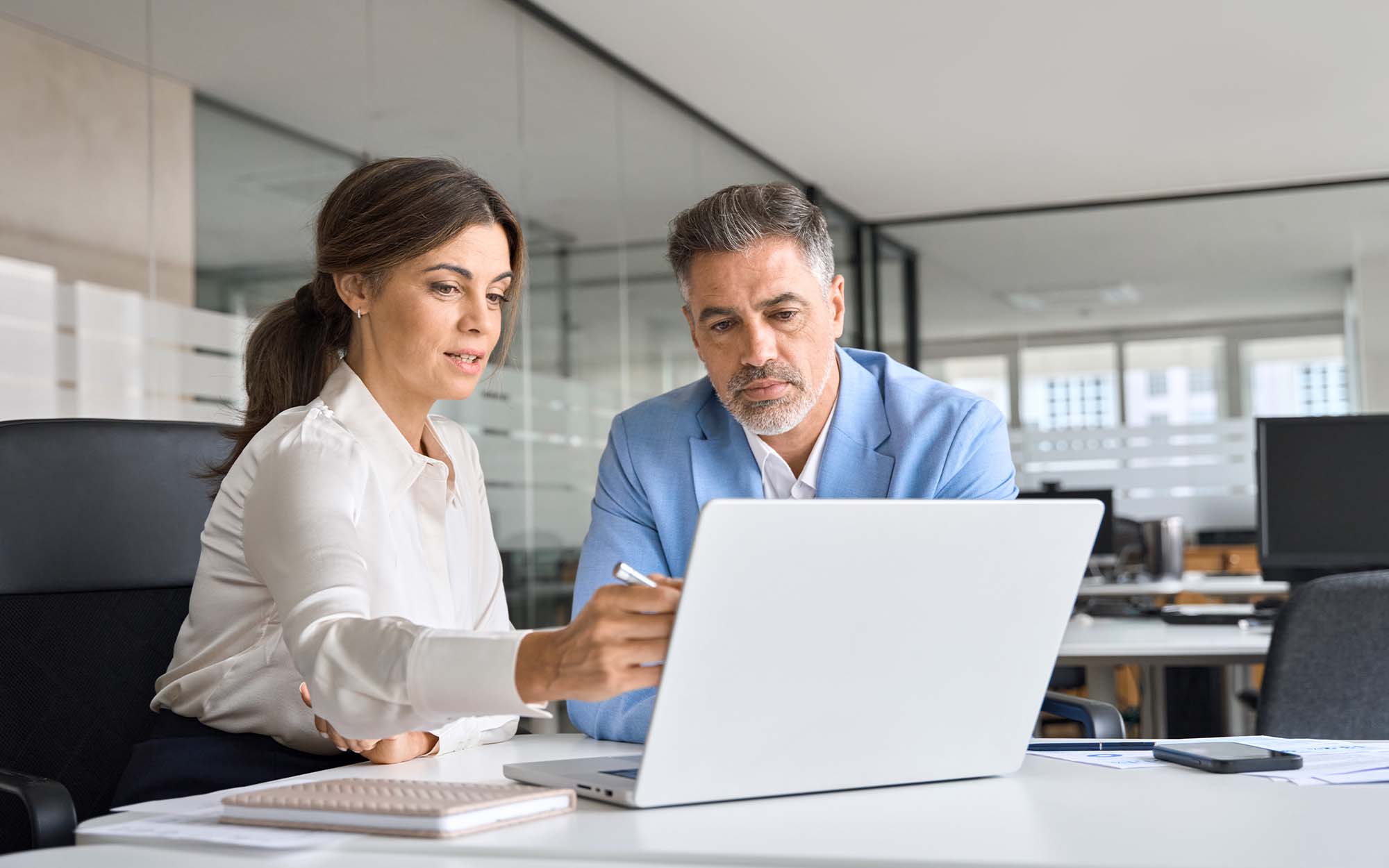 Two business workers looking at laptop