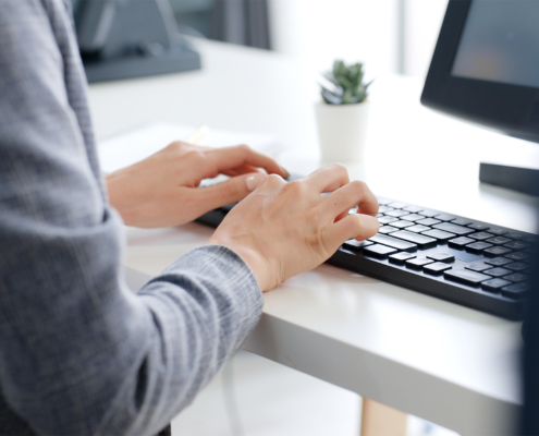 Closeup business people hands typing on keyboard computer desktop for using internet