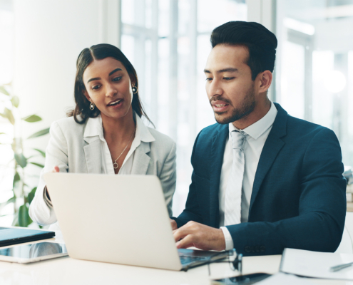 Two workers looking at computer